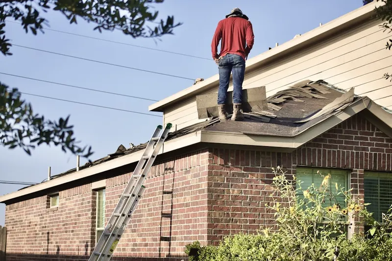 Professional roofer working on a residential roof in Fossil